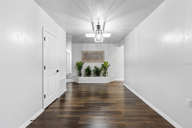 interior space featuring baseboards and wood finished floors