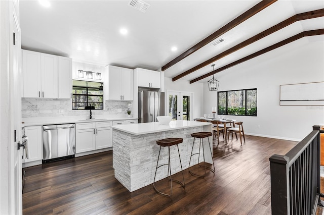 kitchen with visible vents, appliances with stainless steel finishes, tasteful backsplash, and french doors