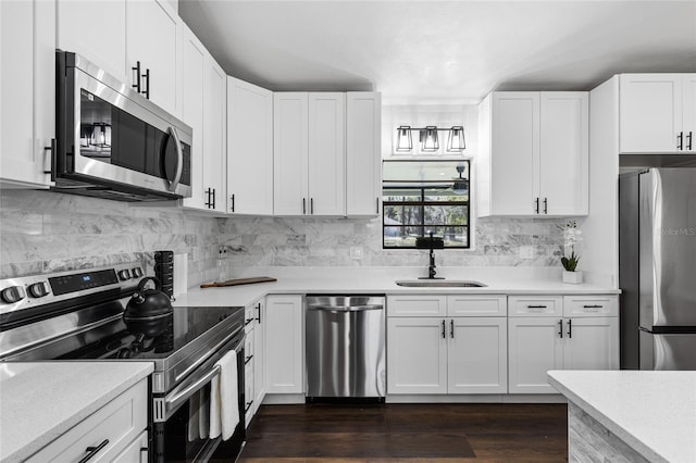 kitchen with stainless steel appliances, a sink, and light countertops