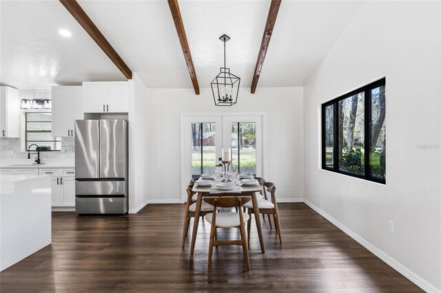 dining room featuring dark wood-style floors, baseboards, and beamed ceiling