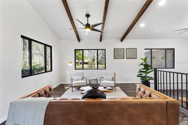 living area with ceiling fan, lofted ceiling with beams, baseboards, and wood finished floors