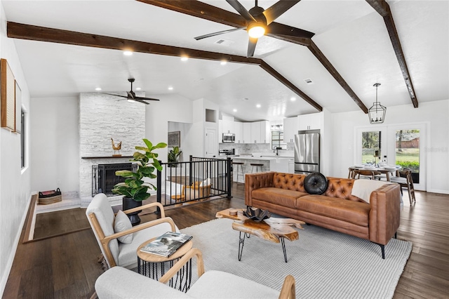 living room with lofted ceiling with beams, a fireplace, baseboards, and dark wood-type flooring