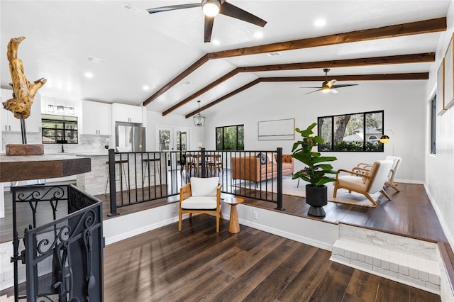 sitting room with lofted ceiling with beams, dark wood finished floors, visible vents, and baseboards