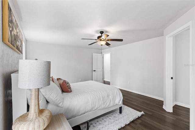 bedroom featuring ceiling fan, baseboards, and wood finished floors