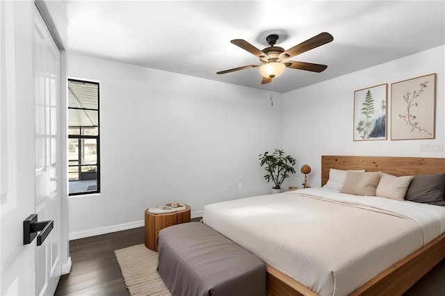 bedroom featuring a ceiling fan, baseboards, and dark wood-style flooring