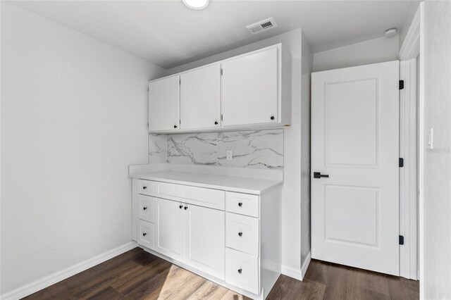 kitchen featuring visible vents, white cabinets, light countertops, tasteful backsplash, and dark wood finished floors