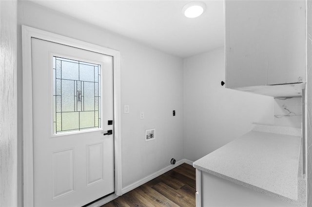 clothes washing area featuring cabinet space, baseboards, dark wood-style floors, hookup for a washing machine, and electric dryer hookup