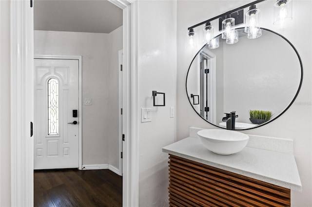 bathroom with vanity, baseboards, and wood finished floors