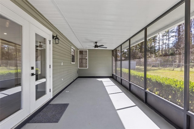 unfurnished sunroom featuring a ceiling fan