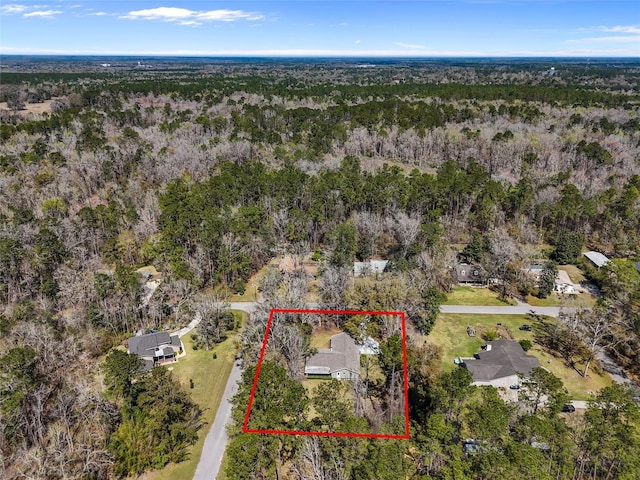 birds eye view of property with a view of trees