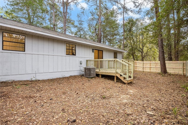 rear view of house with fence and cooling unit