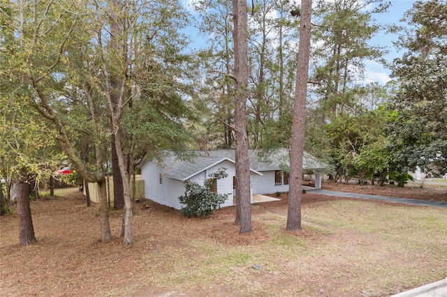 view of front of house with driveway and roof with shingles