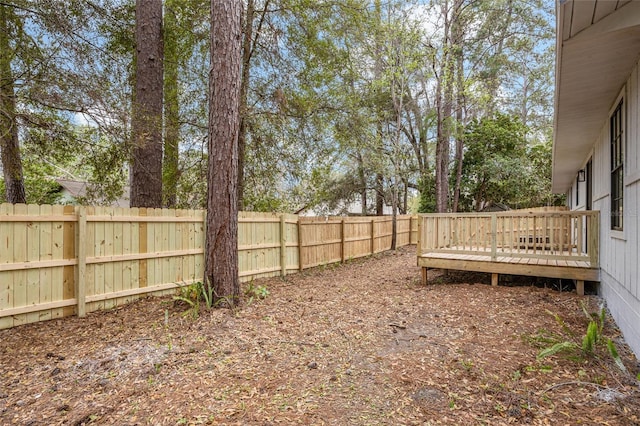 view of yard featuring a fenced backyard and a wooden deck