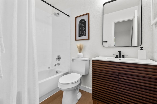 bathroom with shower / bath combo, baseboards, toilet, wood finished floors, and vanity