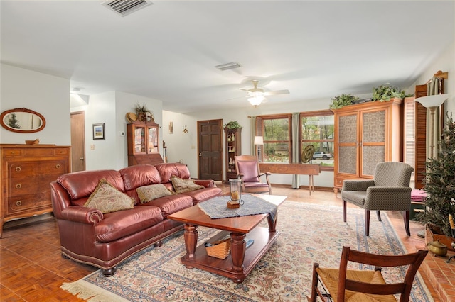 living room featuring visible vents and ceiling fan