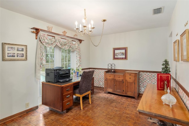 office area featuring a chandelier, a wainscoted wall, visible vents, and baseboards