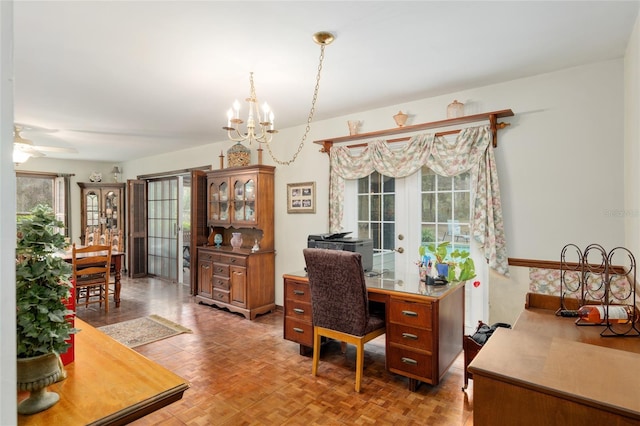 office space with ceiling fan with notable chandelier