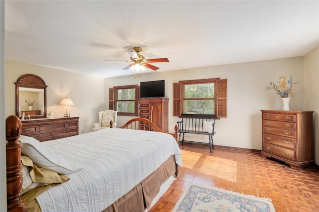 bedroom with ceiling fan and baseboards