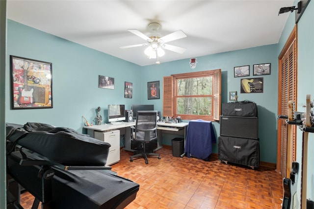 home office featuring ceiling fan and baseboards