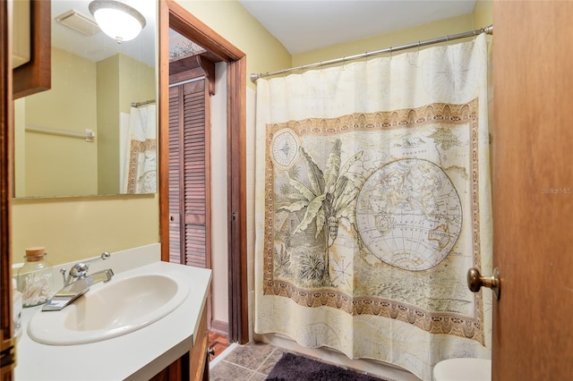 bathroom featuring tile patterned flooring and vanity