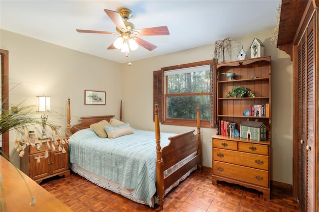 bedroom featuring ceiling fan and baseboards