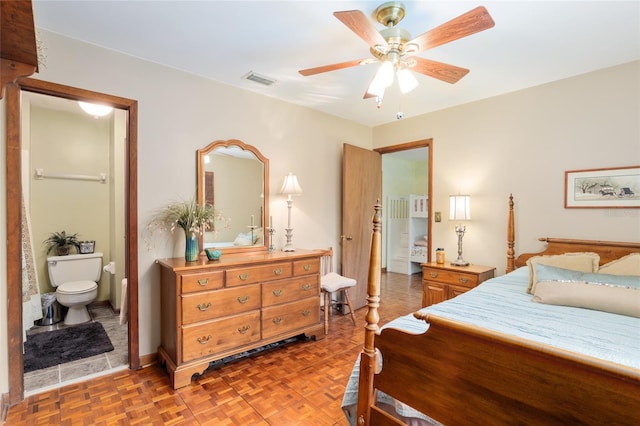 bedroom featuring baseboards, ceiling fan, visible vents, and connected bathroom