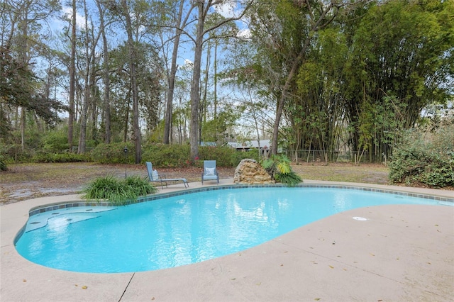 outdoor pool with a patio area