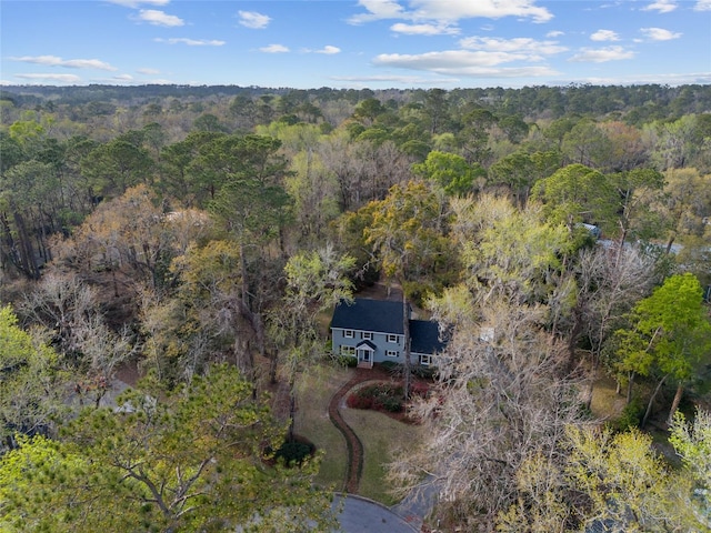 bird's eye view with a wooded view