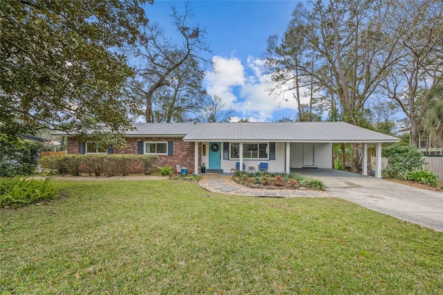 ranch-style home with brick siding, concrete driveway, metal roof, a carport, and a front lawn