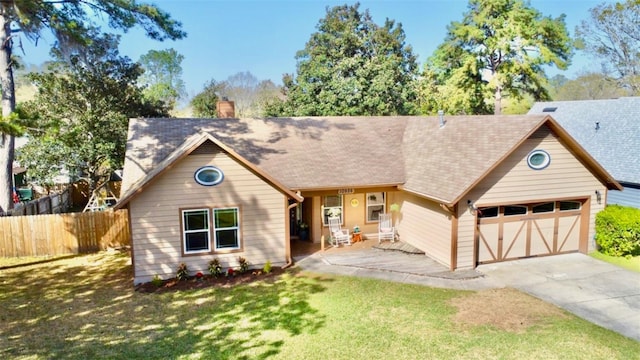 view of front of house featuring a front lawn, fence, concrete driveway, a chimney, and an attached garage