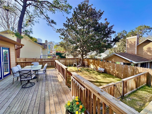 wooden deck featuring outdoor dining space and a fenced backyard