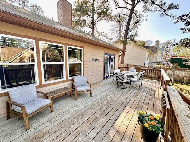 deck with fence and outdoor dining area