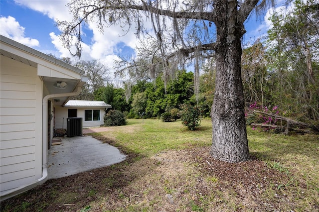 view of yard featuring central AC unit and a patio area