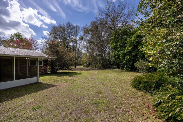 view of yard featuring a sunroom