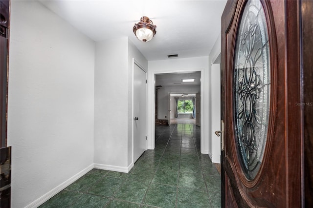 foyer entrance featuring visible vents and baseboards