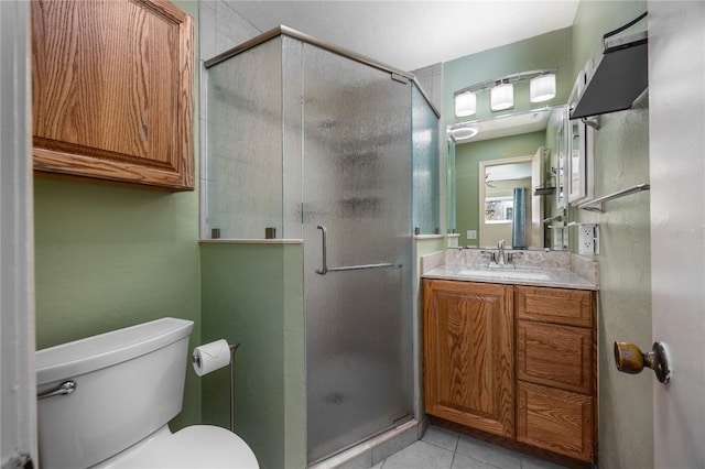 full bathroom with tile patterned floors, a shower stall, toilet, and vanity