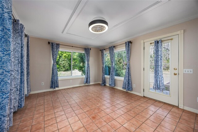 spare room featuring crown molding and baseboards