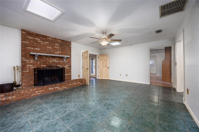 unfurnished living room featuring visible vents, baseboards, a ceiling fan, and a fireplace