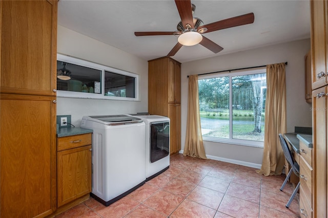 clothes washing area featuring washer and dryer, baseboards, cabinet space, and light tile patterned flooring