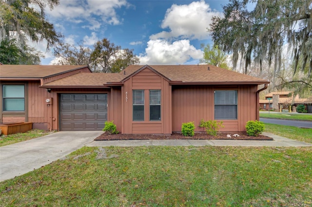 view of front of house featuring a garage, concrete driveway, a front lawn, and roof with shingles