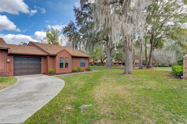 view of yard with concrete driveway and an attached garage