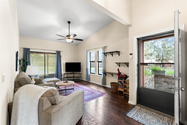 living area with lofted ceiling, ceiling fan, baseboards, and wood finished floors