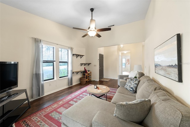 living area featuring baseboards, dark wood-style flooring, visible vents, and a ceiling fan