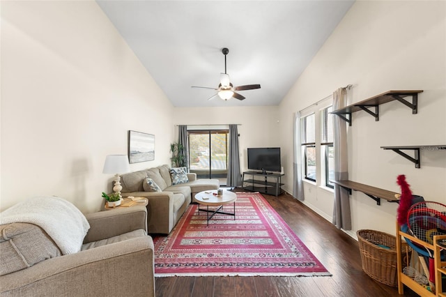 living area featuring a ceiling fan, lofted ceiling, baseboards, and hardwood / wood-style flooring