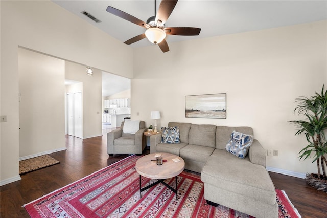 living area with a ceiling fan, wood finished floors, visible vents, and baseboards