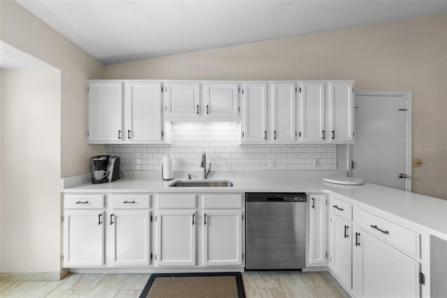 kitchen featuring dishwasher, light countertops, a sink, and white cabinetry