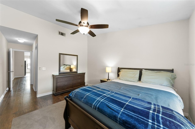 bedroom with a ceiling fan, baseboards, visible vents, and wood finished floors