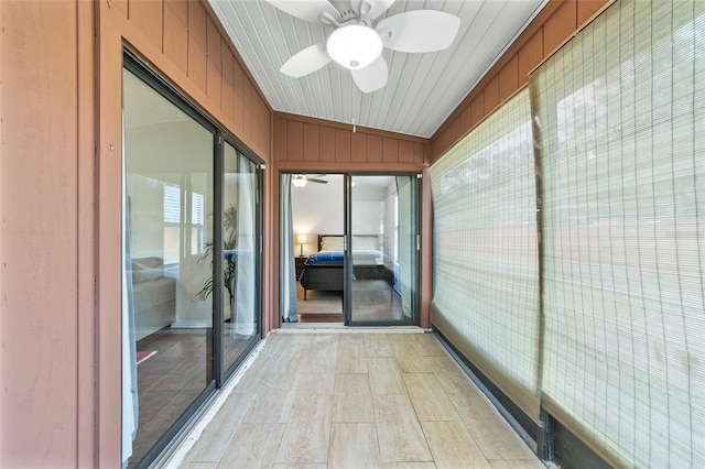 unfurnished sunroom with a ceiling fan