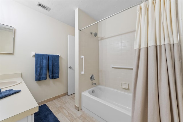 full bath with shower / bath combination with curtain, vanity, visible vents, and baseboards