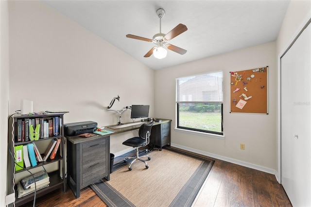 home office with lofted ceiling, ceiling fan, baseboards, and wood finished floors